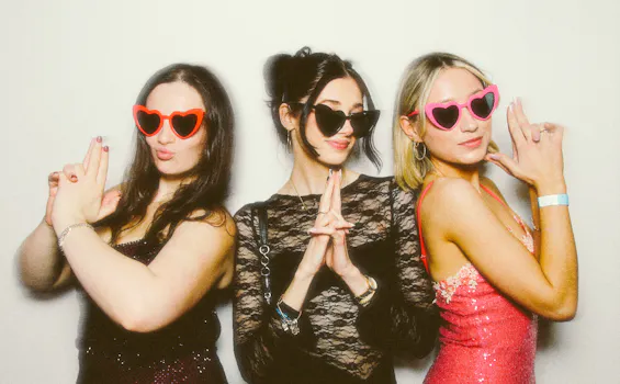 3 friends posing in James Bond style for a private party