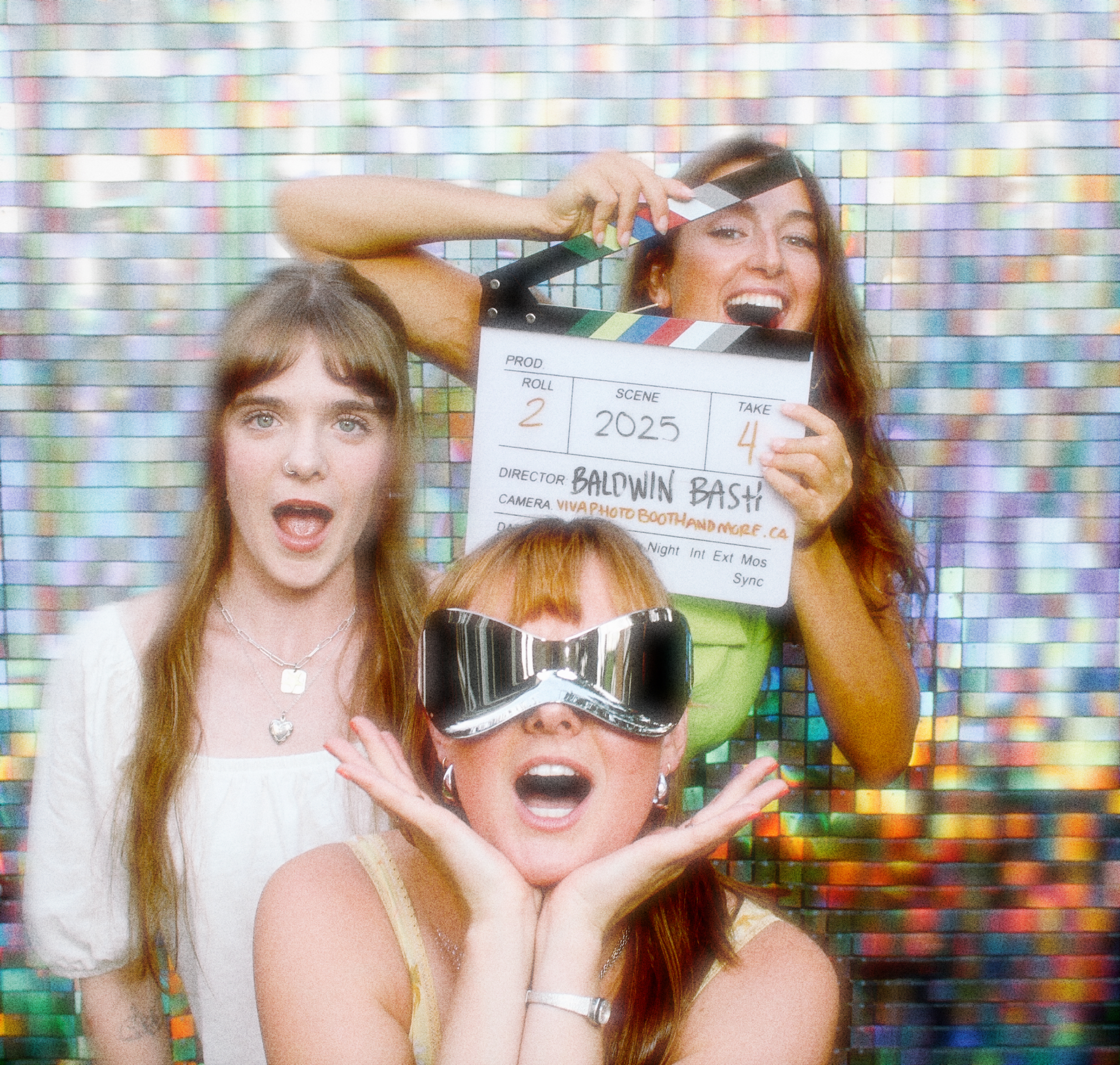 Three friends having fun with lots of props to take an incredible photo.