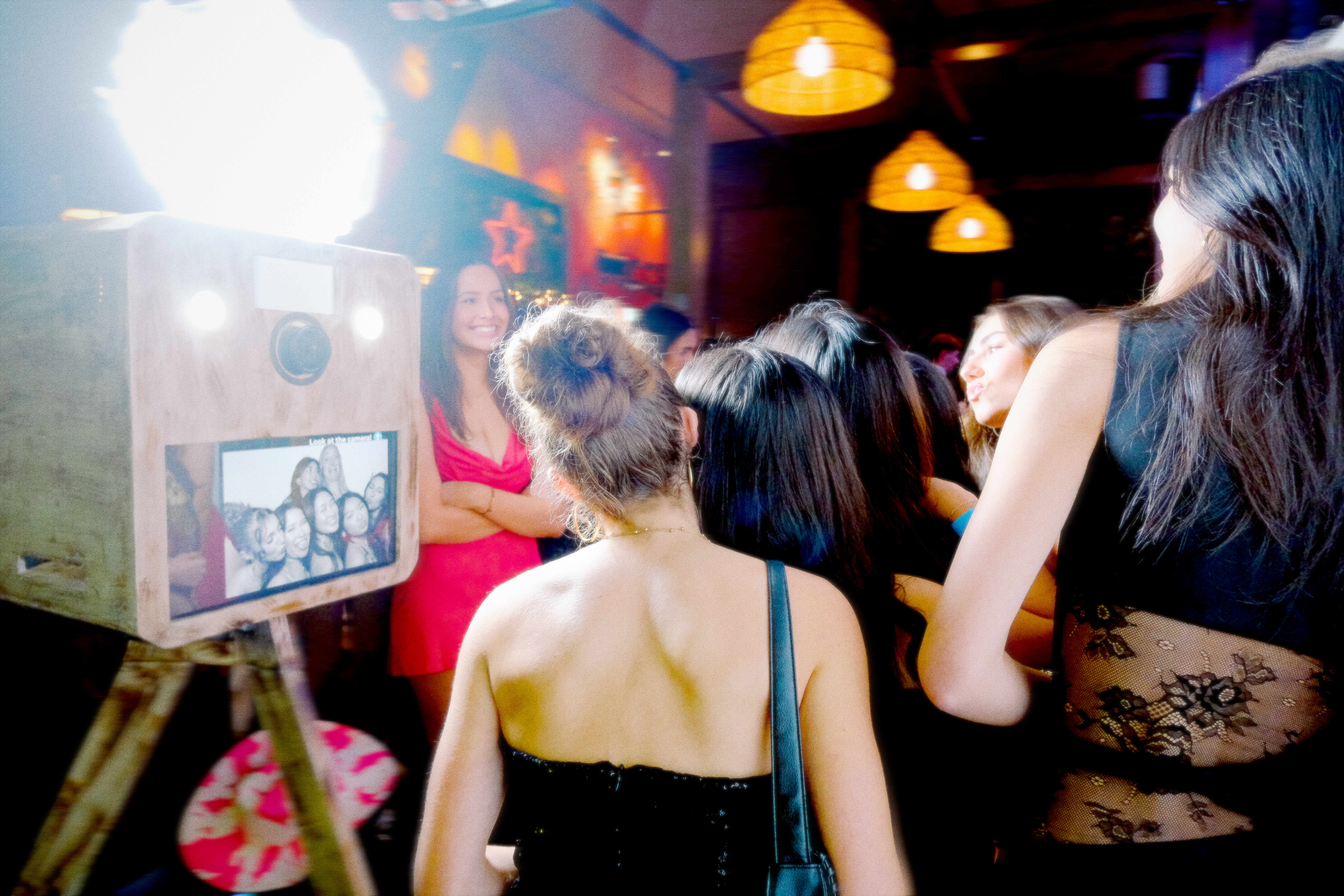 People posing in front of the photo booth
