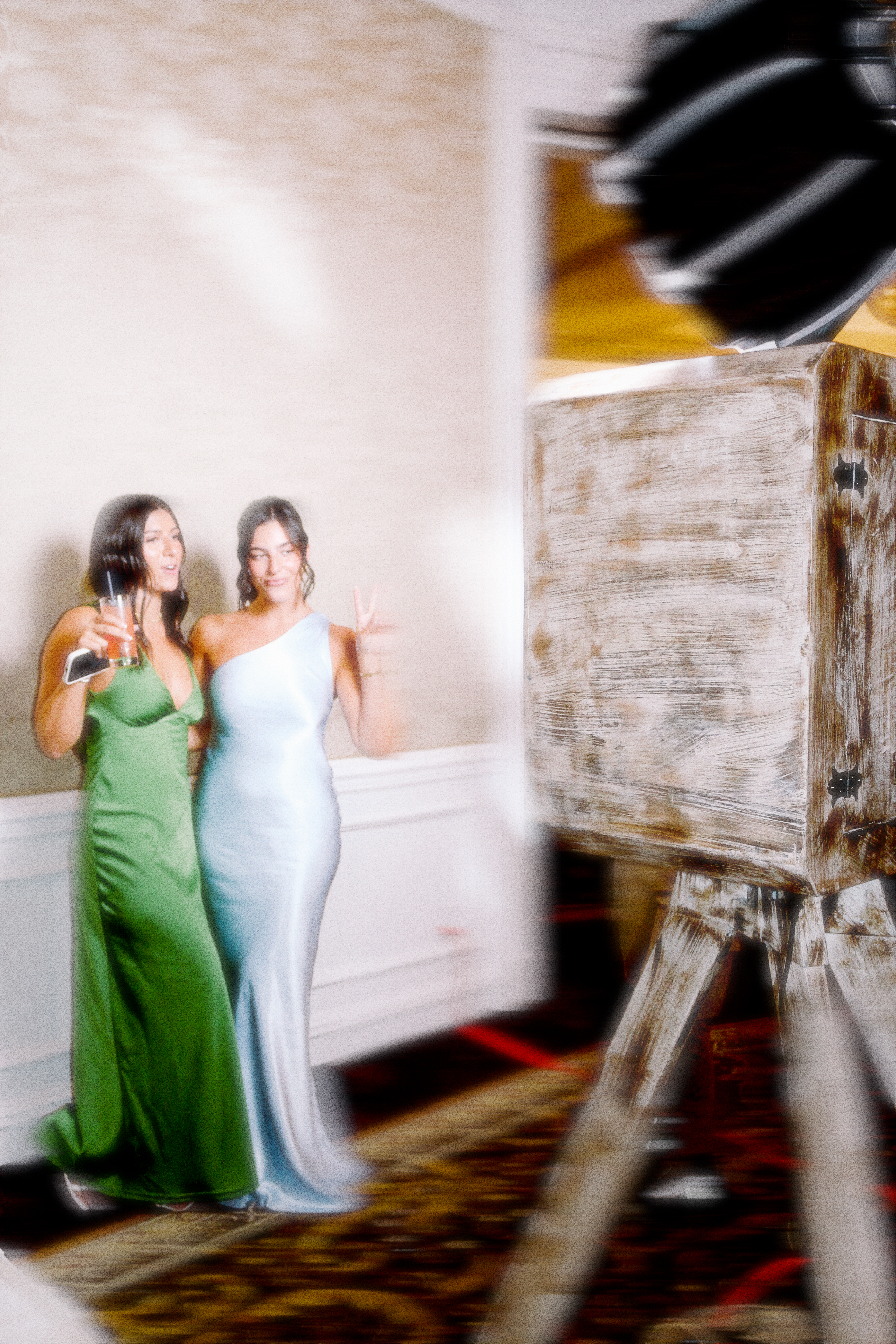 2 wedding guests posing in front of the PhotoBooth