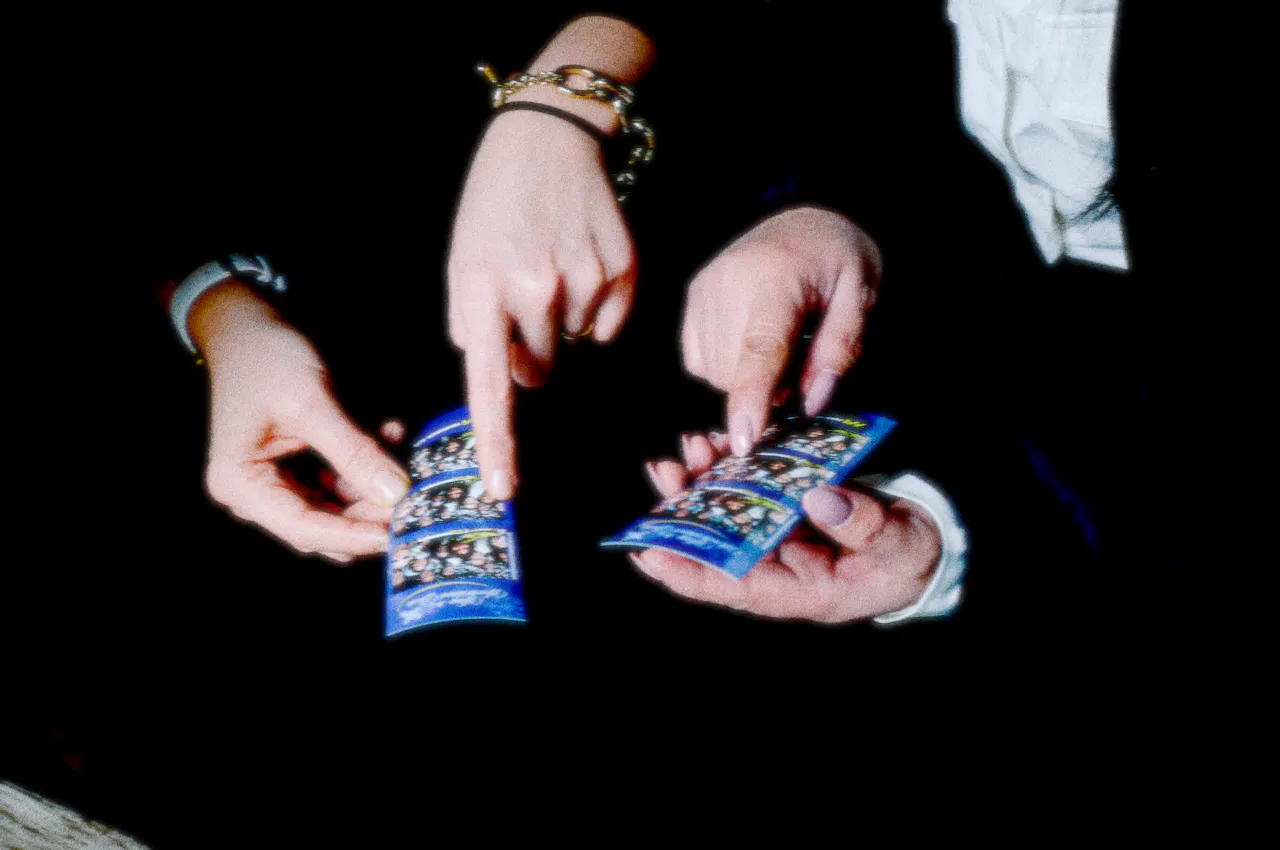 Two people holding their Viva Photo Booth prints