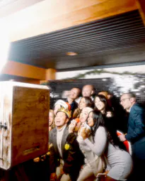 A group of colleagues posing in front of the photo booth at a corporate event