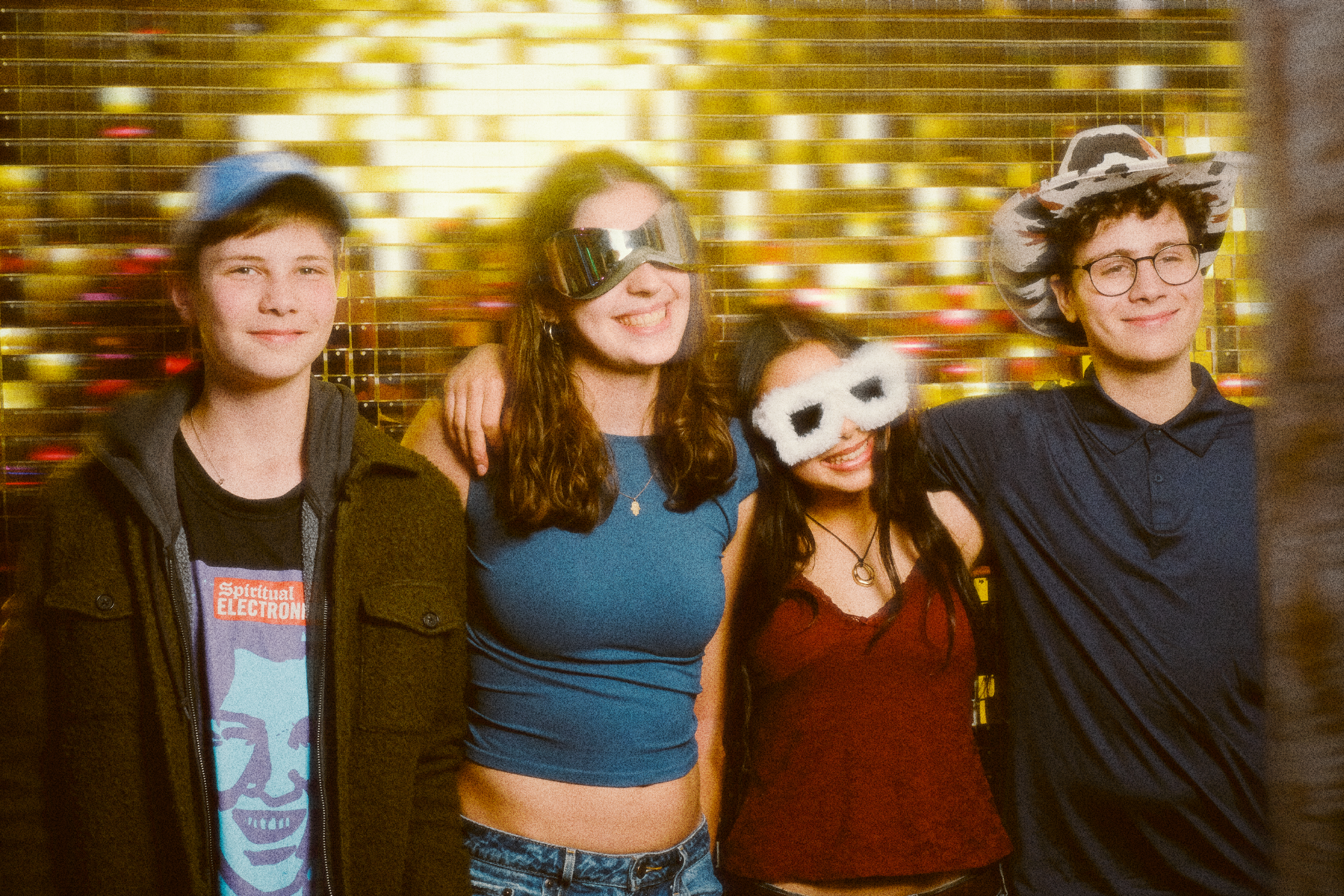 Four children and a teenager posing in front of the photo booth for a children party.