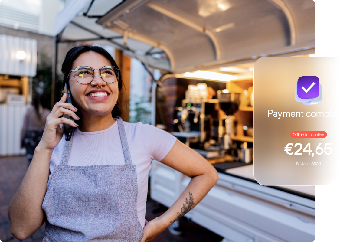 Outdoor food van merchant smiling after successfully accepting an offline payment with Viva.com, allowing business to continue without a network connection.