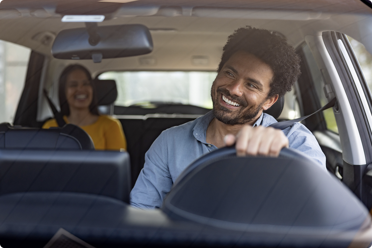 Mobility payment solutions for taxis and transport — smiling taxi driver with a passenger, accepting payments via Tap on Any Device technology, viva.com mobility payments