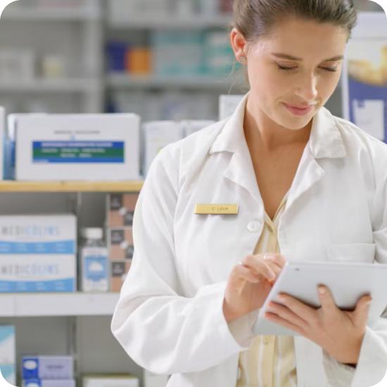 Female pharmacist using a tablet in a pharmacy store