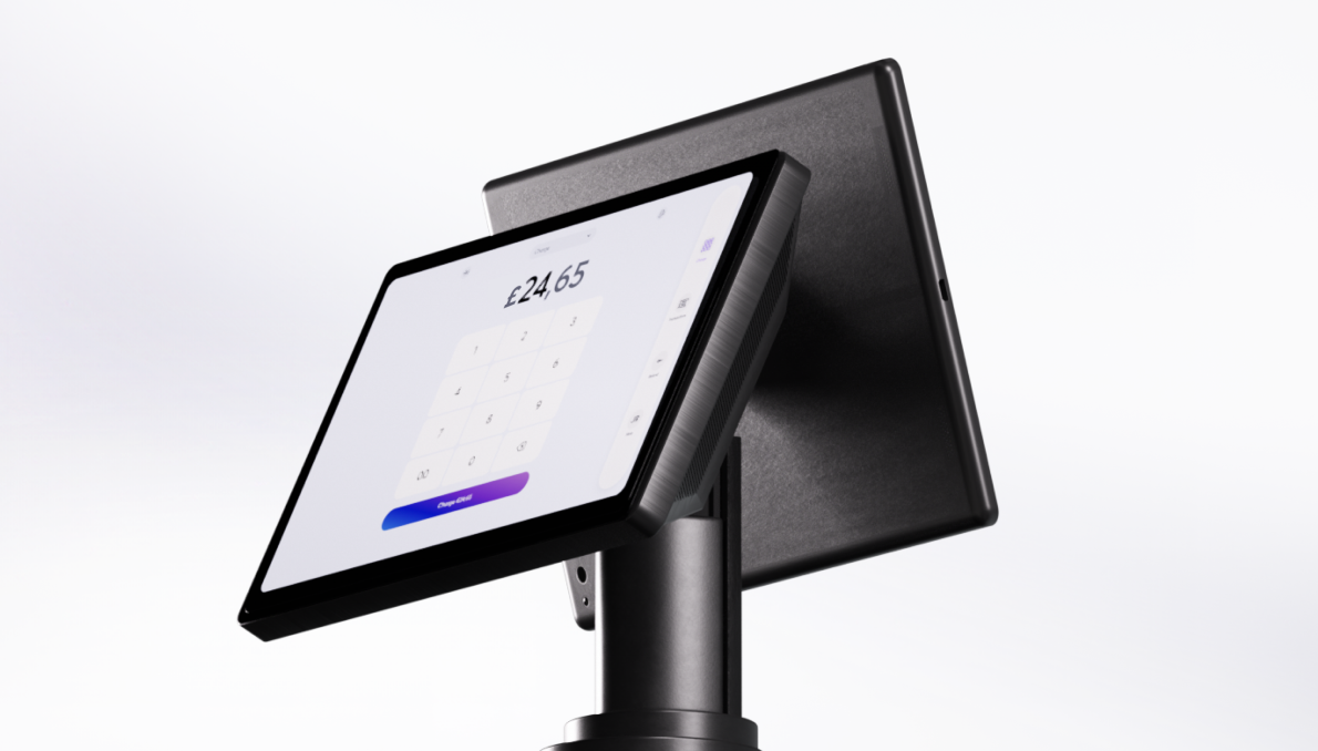 Black dual-screen POS terminal showing £24.65 payment amount on merchant-facing display with keypad and customer-facing screen, mounted on stand