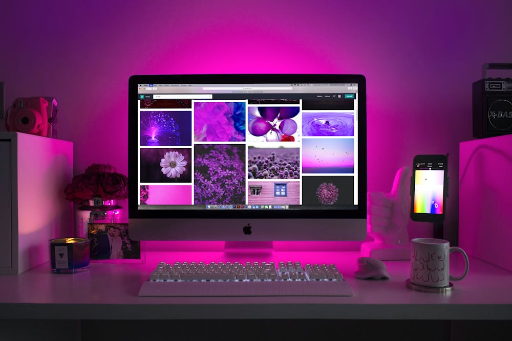 Mac on desk with purple background light