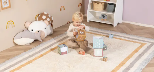 Vloerkleed in een ingerichte kinderkamer met zachte kleuren