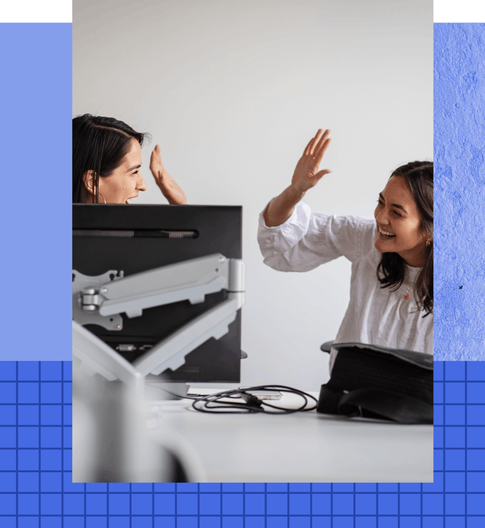 Students at computer high-fiving