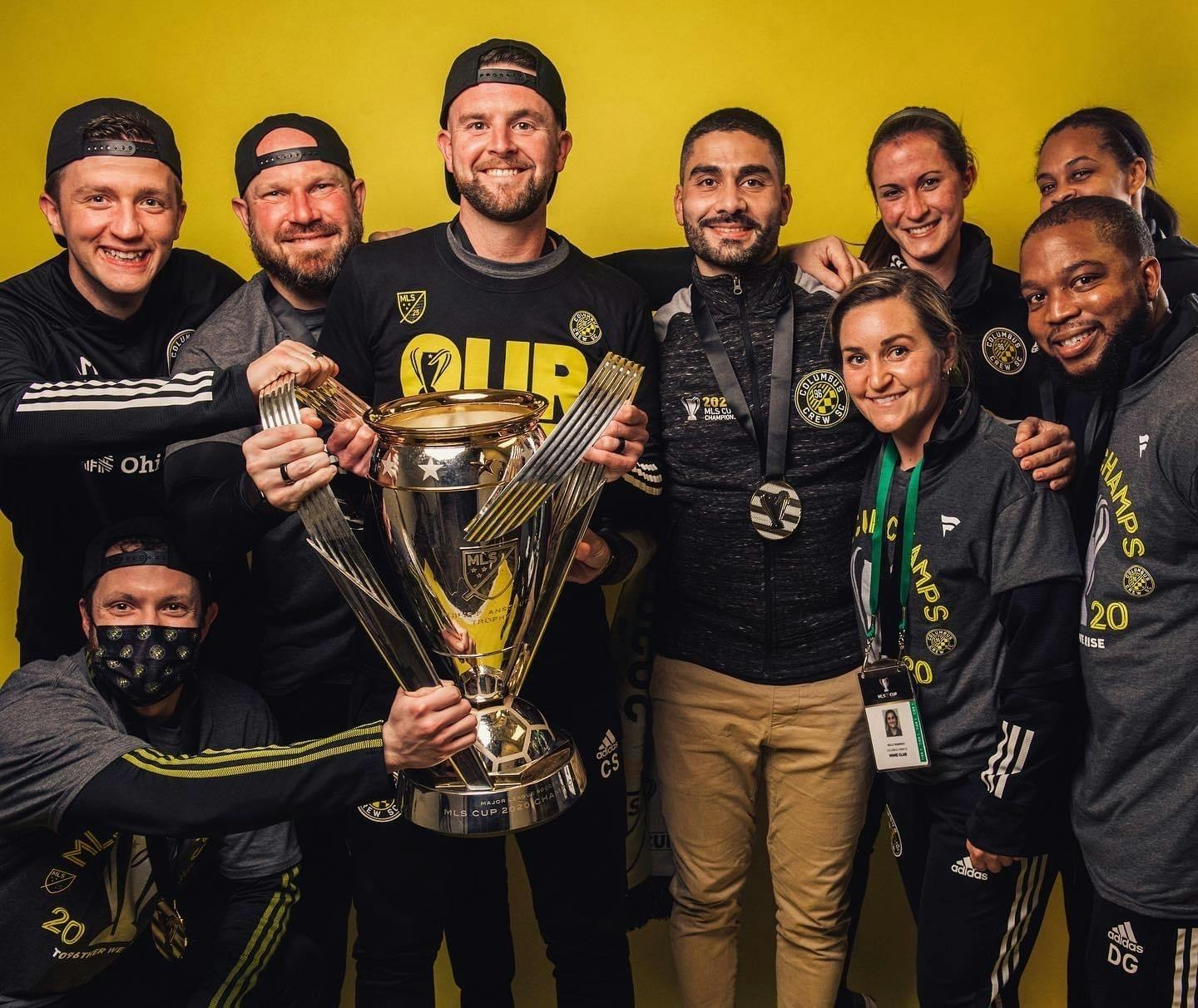 Chris holding trophy with colleagues (photo courtesy Columbus Crew)