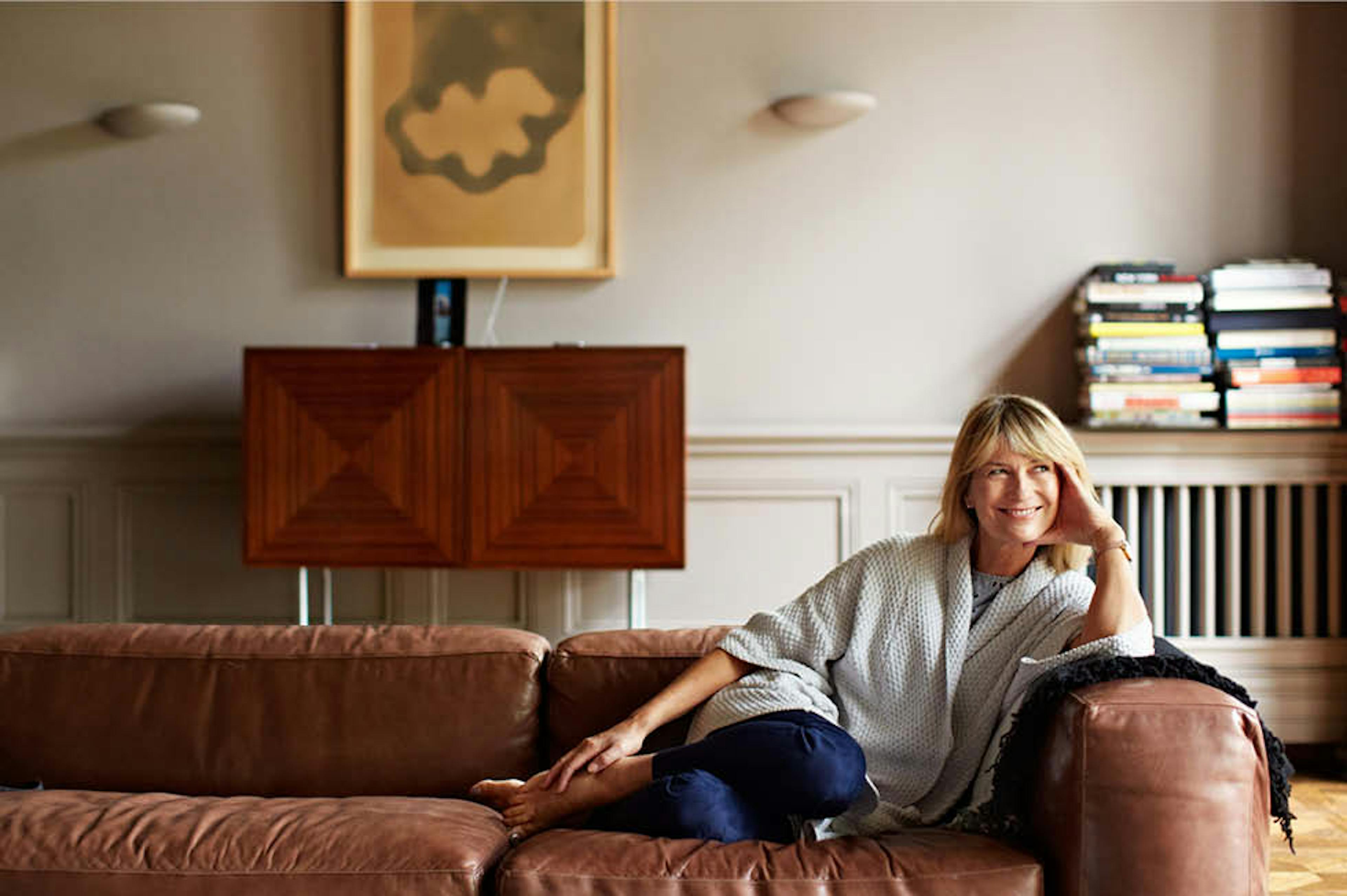 Women sitting on a leather couch