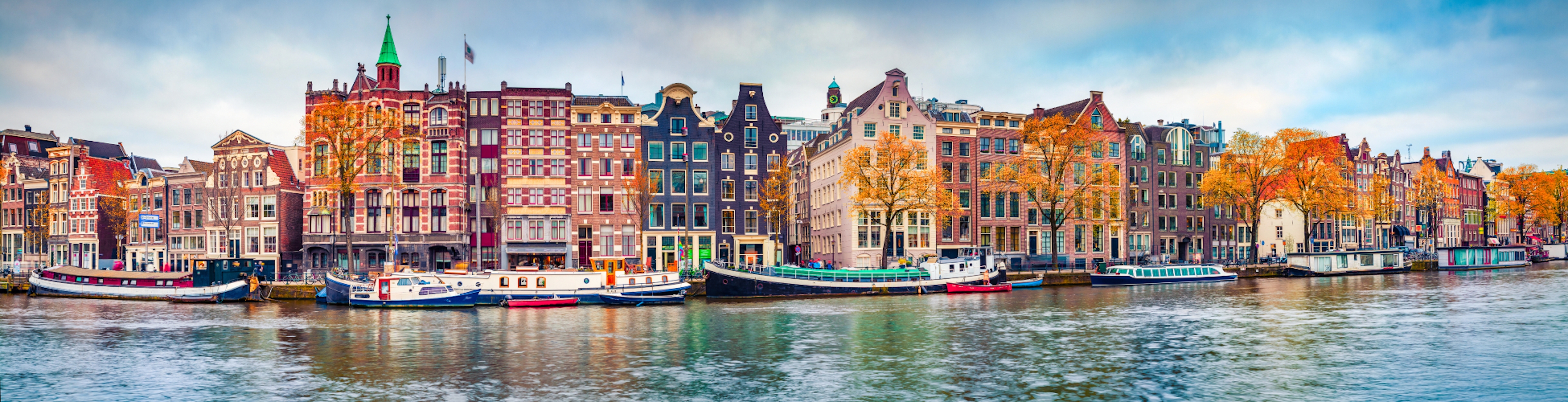 Panoramic autumn view of Amsterdam city. Famous Dutch channels and great cityscape. Colorful morning scene of Netherlands, Europe