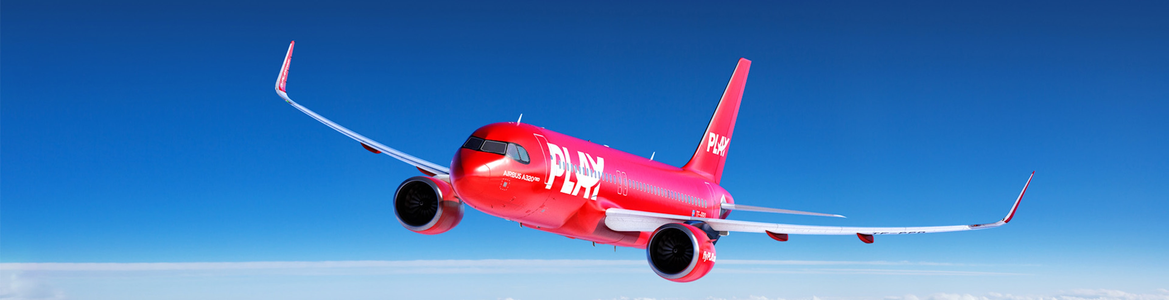 Red PLAY airlines aircraft flying above the clouds with a blue sky