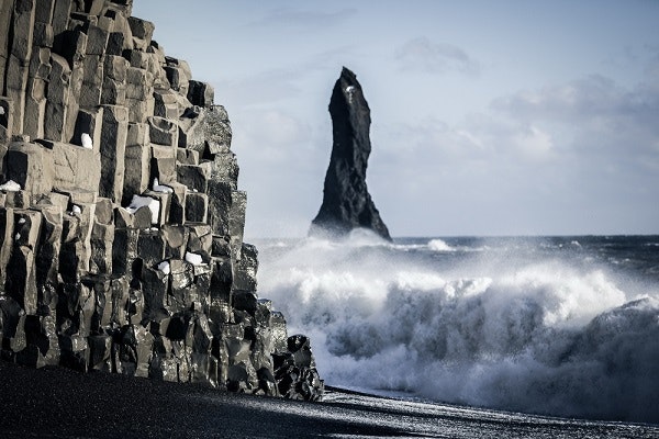 Reynisfjara beach in Iceland with columnar basalt and powerful waves