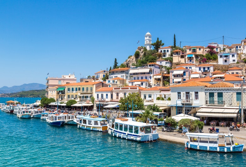 view of a city by the water in a summer day