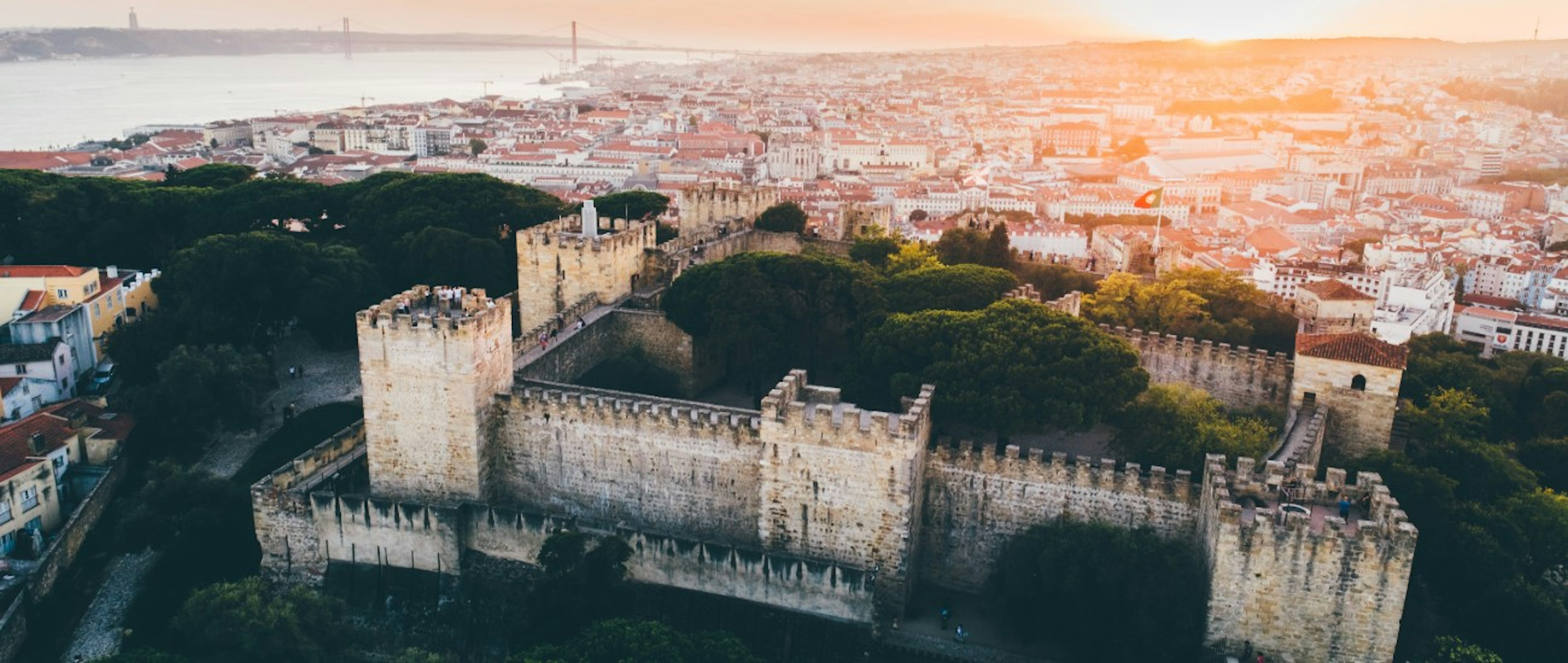 aerial view of fortress on hill in Lisbon at sunset