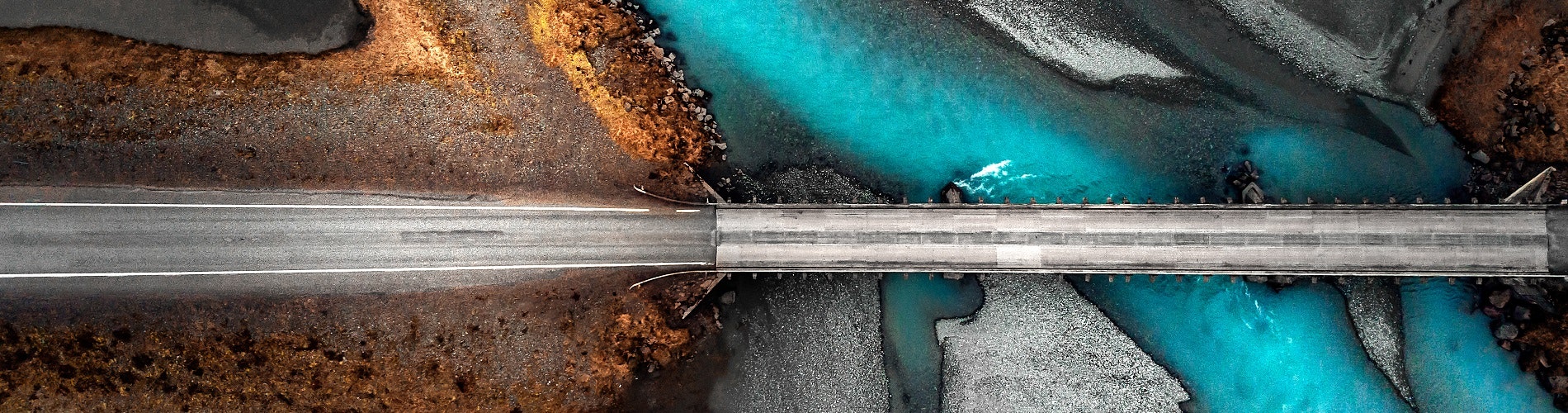Aerial photo of a road and bridge in rural Iceland