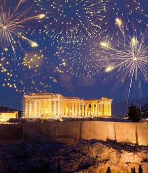 Fireworks going off in the night sky above the Acropolis in Athens, Greece