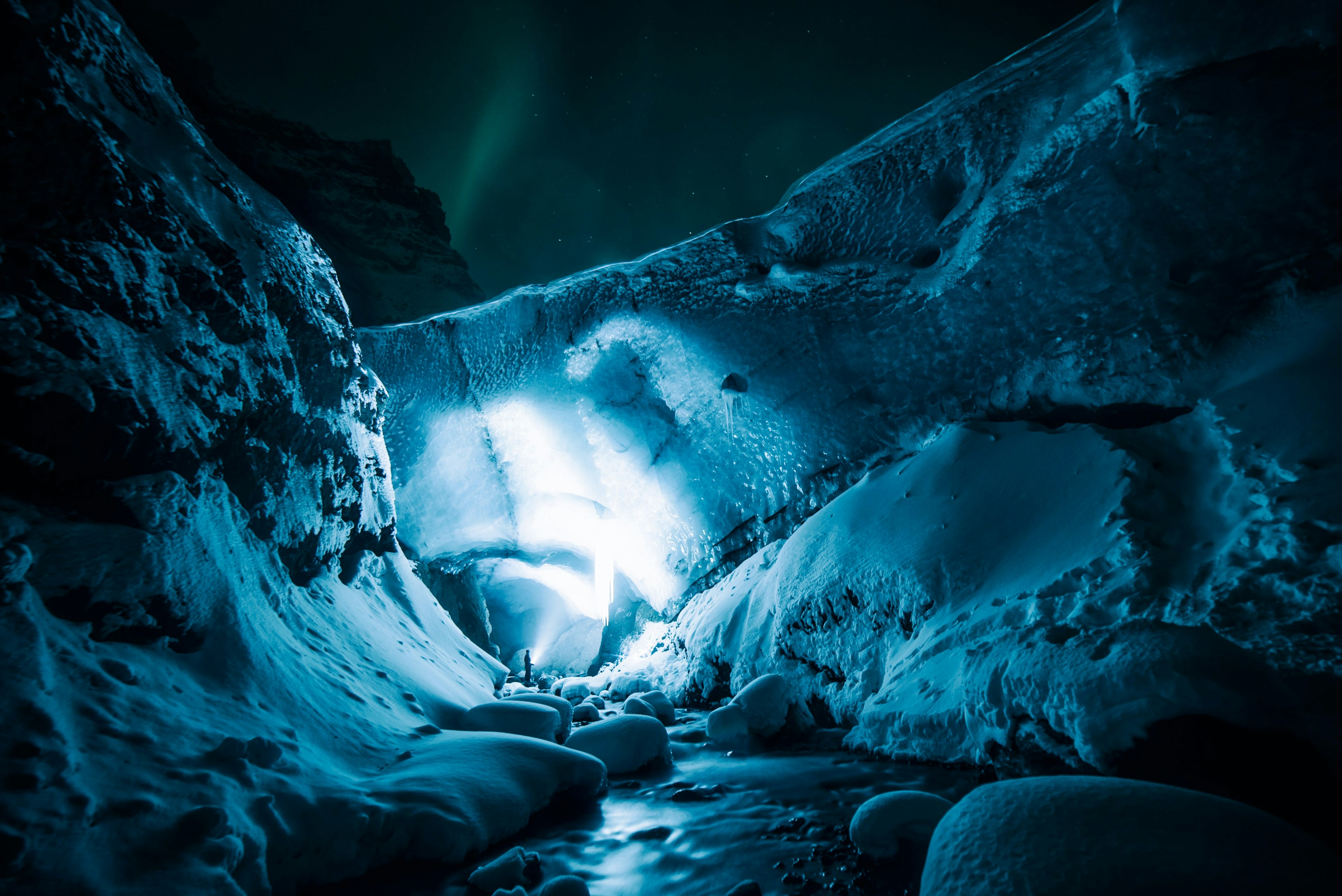 An illuminated ice cave in Iceland in winter