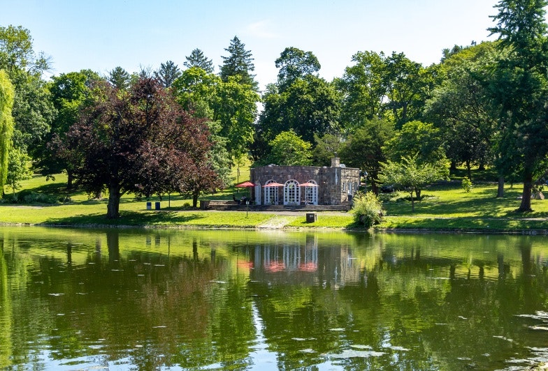 Landscape view of Downing Park's pond known as The Polly and the Shelter House reflecting in it, Newburgh