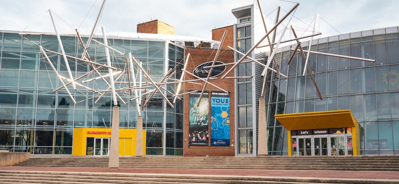 Front stairs and entrance to Maryland Science center with metal sculpture out front