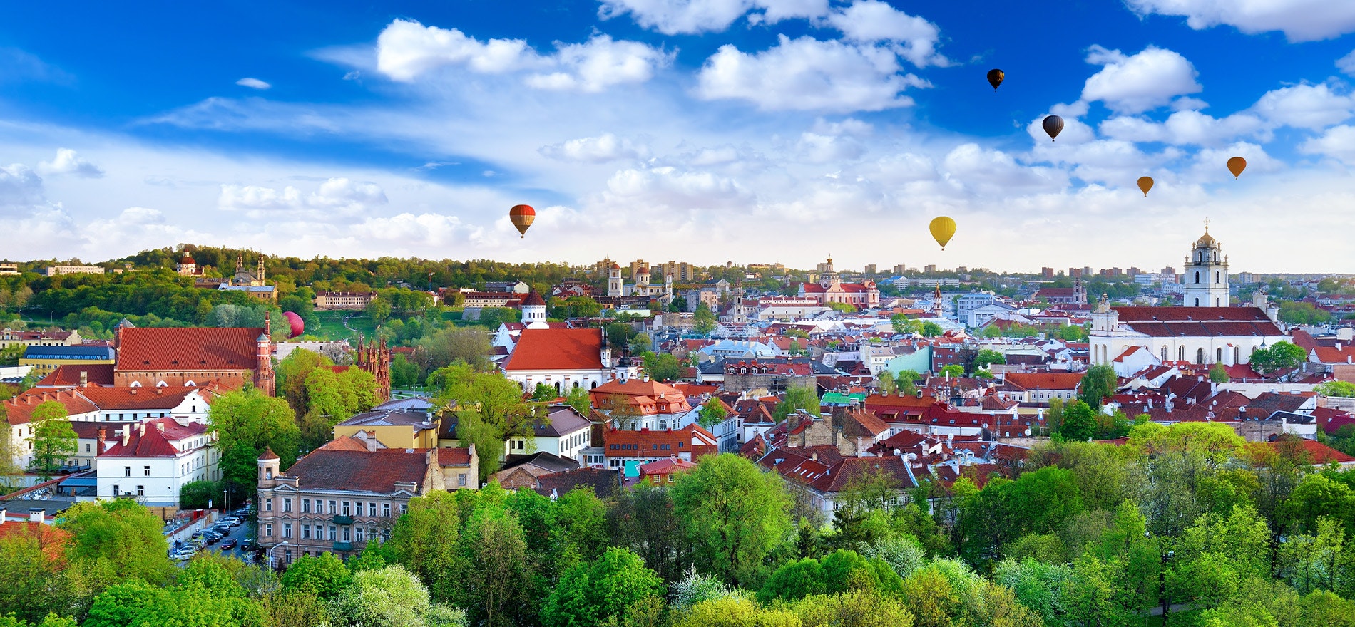 Colorful image of Vilnius with hot air balloons in the sky