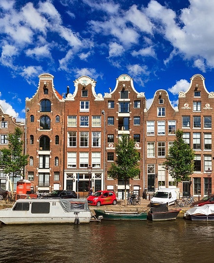 A picturesque view over the historical buildings on the banks of a canal in Amsterdam