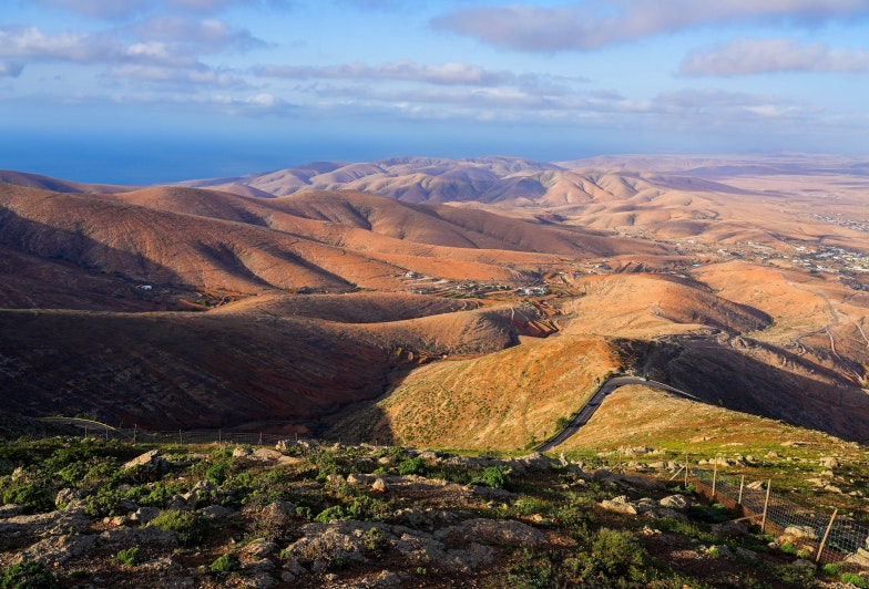 Panoramic view over sandy mountains eroded by the wind in the west of Fuerteventura island from the Mirador of Morro Velosa in the Rural park of Betancuria, Canary Islands, Spain