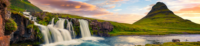 Summer sunset on famous Kirkjufellsfoss Waterfall and Kirkjufell mountain. Colorful evening panorama of Snaefellsnes peninsula, Iceland, Europe