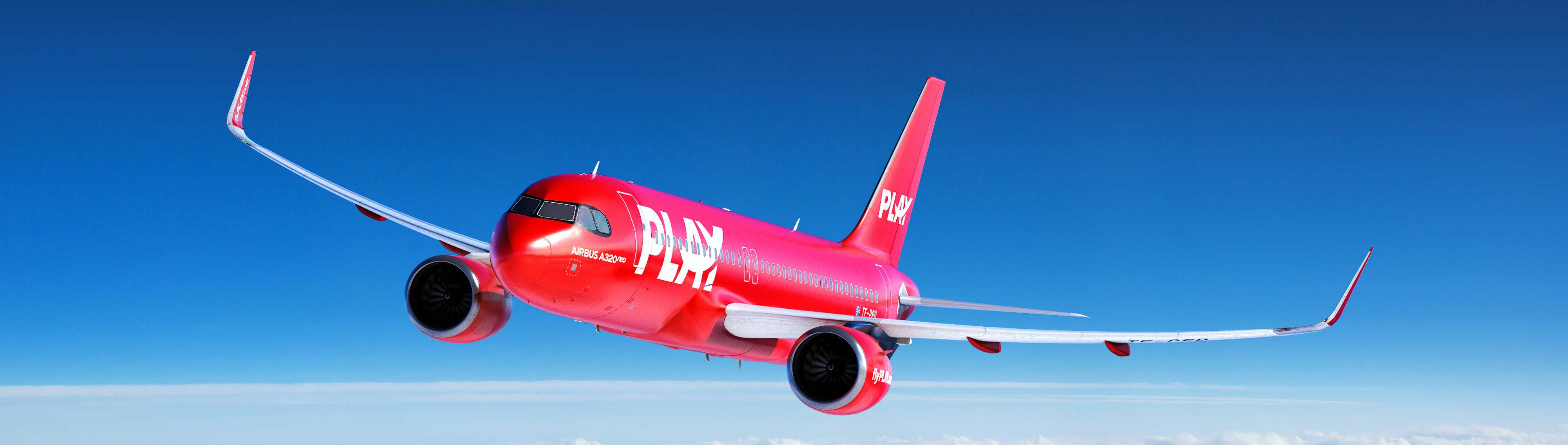 red play aircraft flying in blue sunny skies