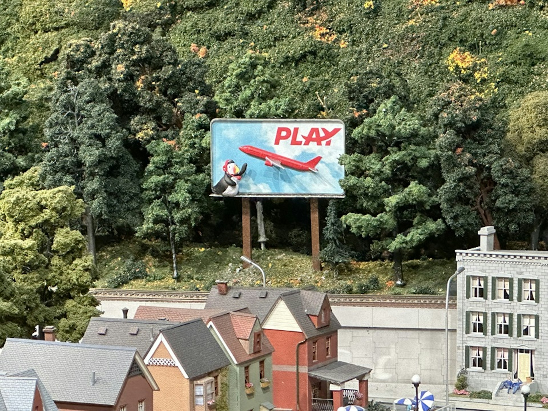Playfin sitting on a PLAY airlines billboard in the heart of Hamilton at Little Canada