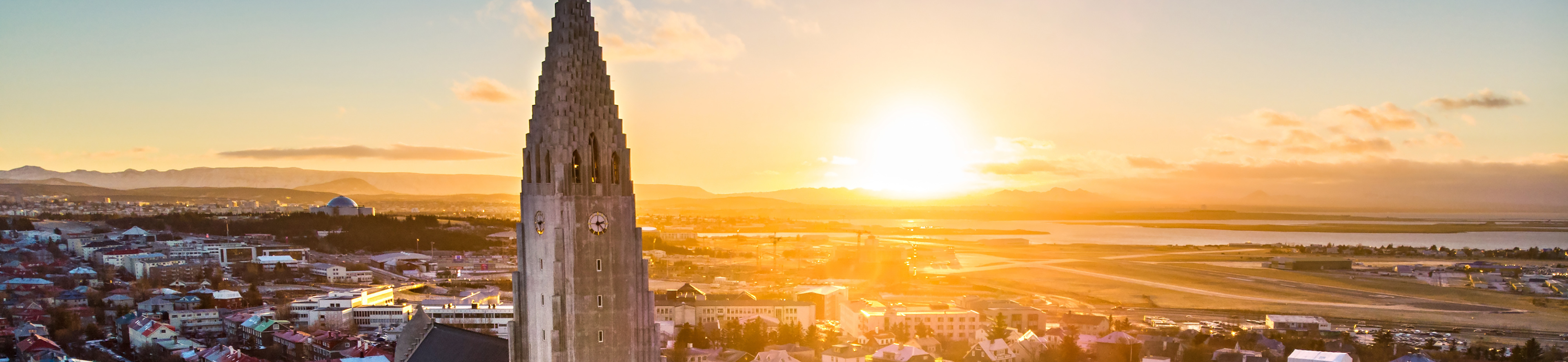 An aerial photo of Hallgrímskirkja church in Reykjavik at sunset with a view of the city in the background