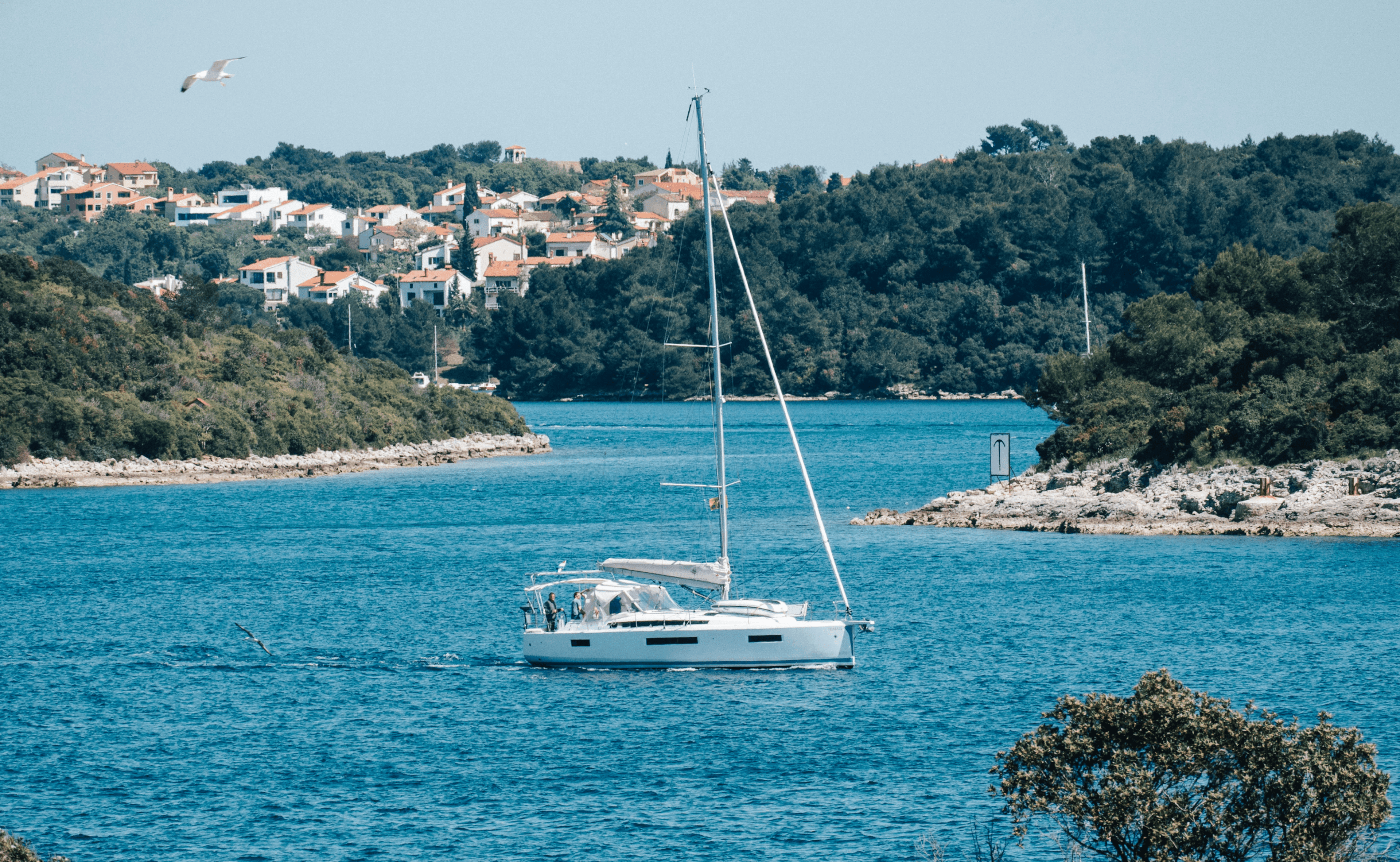 A white sailboat by the coast of Pula in Croatia