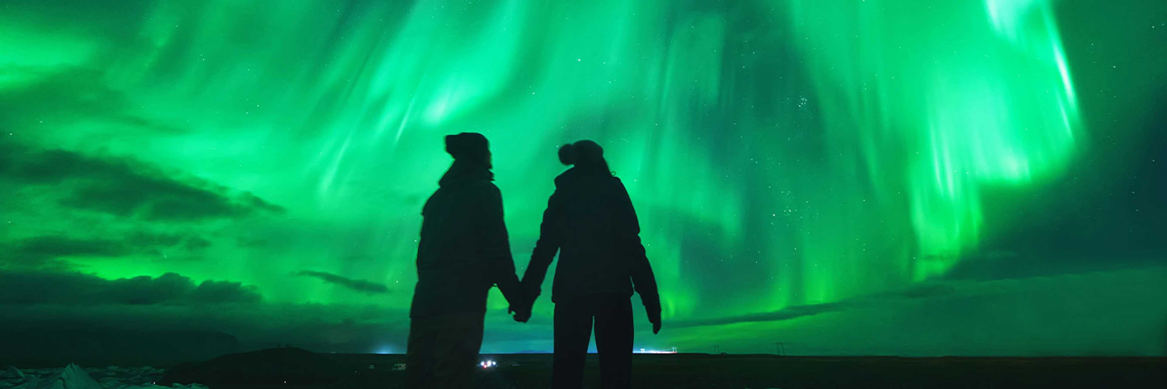 couple enjoying the northern lights in Iceland