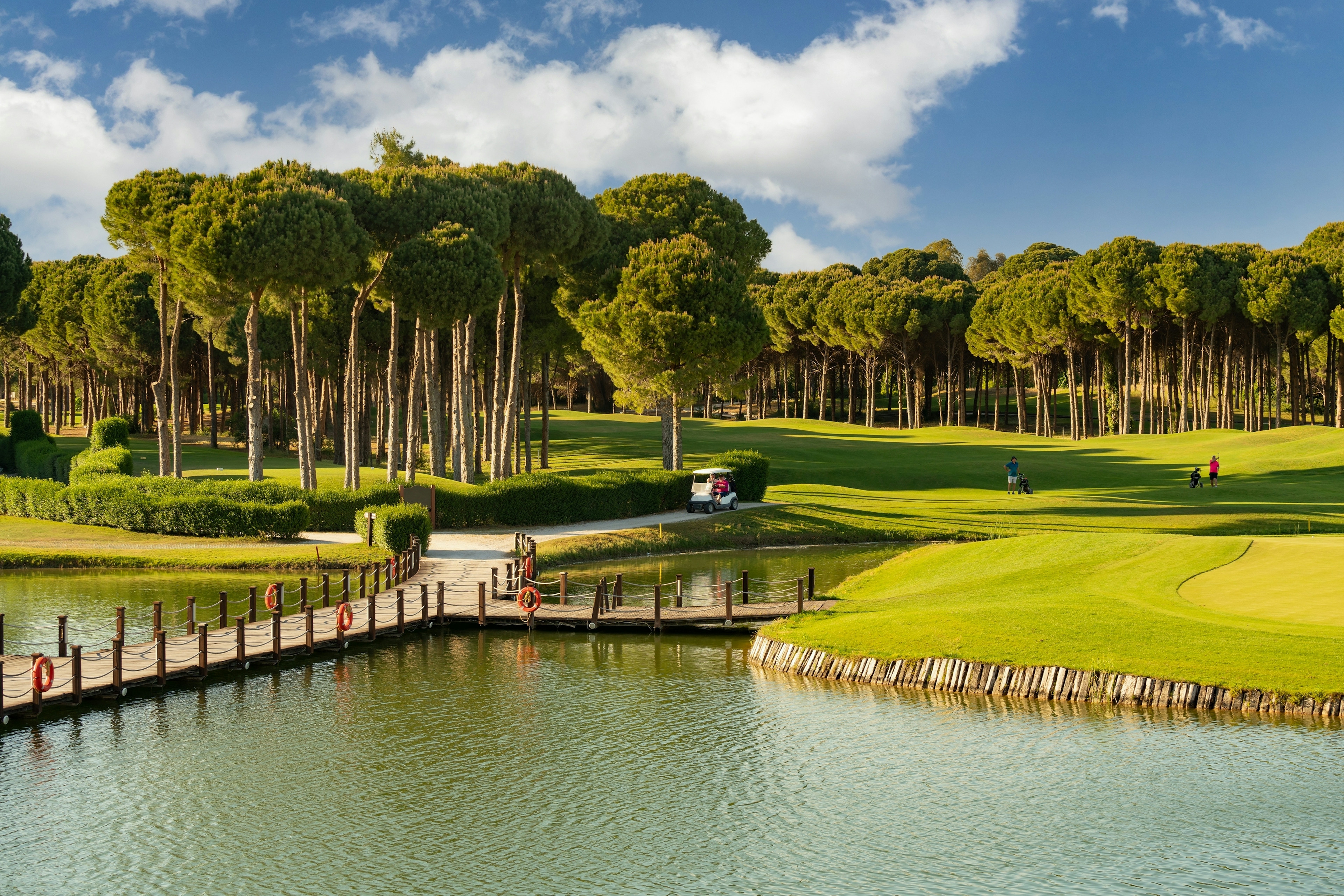 Golf course in Belek, Turkey with lake, golf cart and players