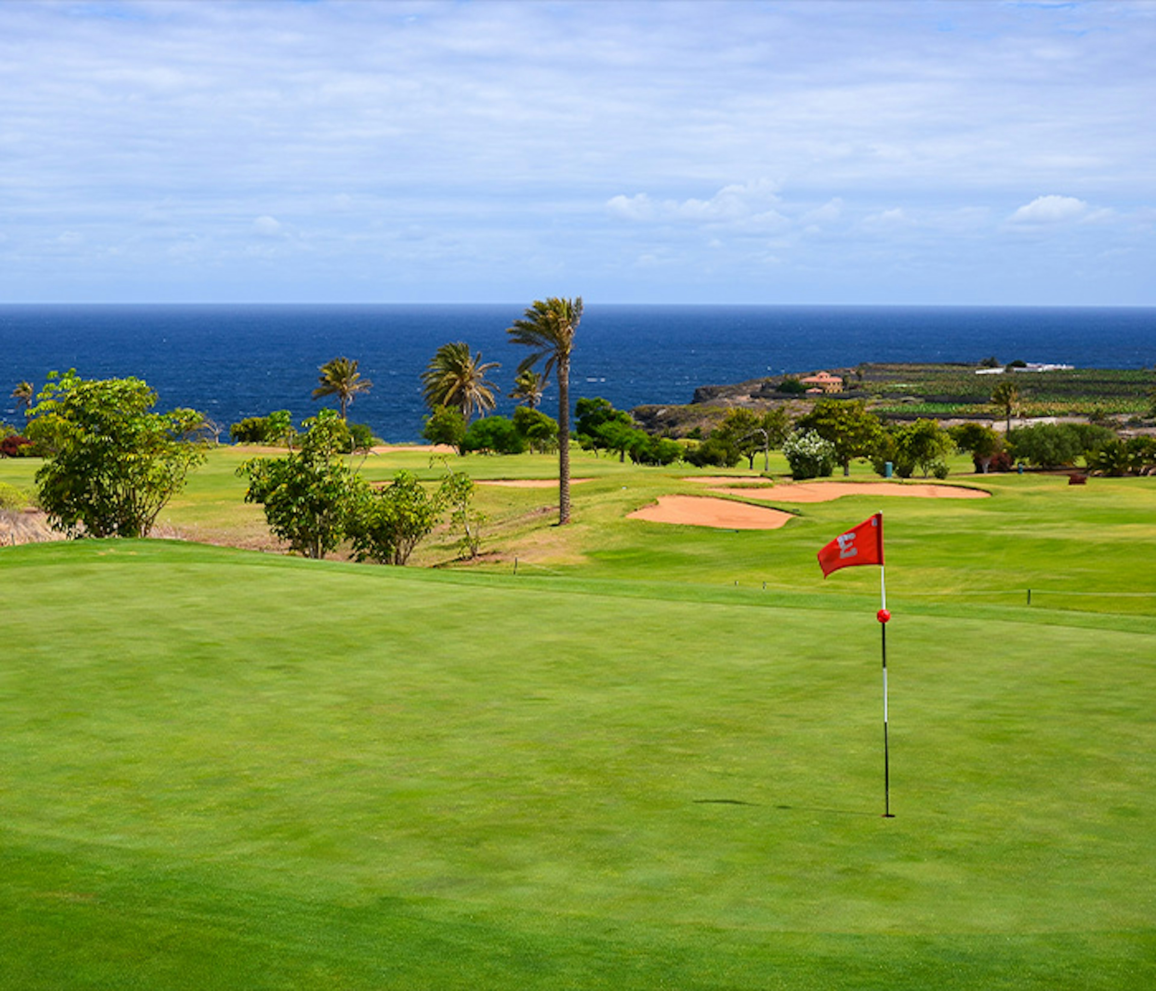 Blue skies and green greens on a golf course in Tenerife