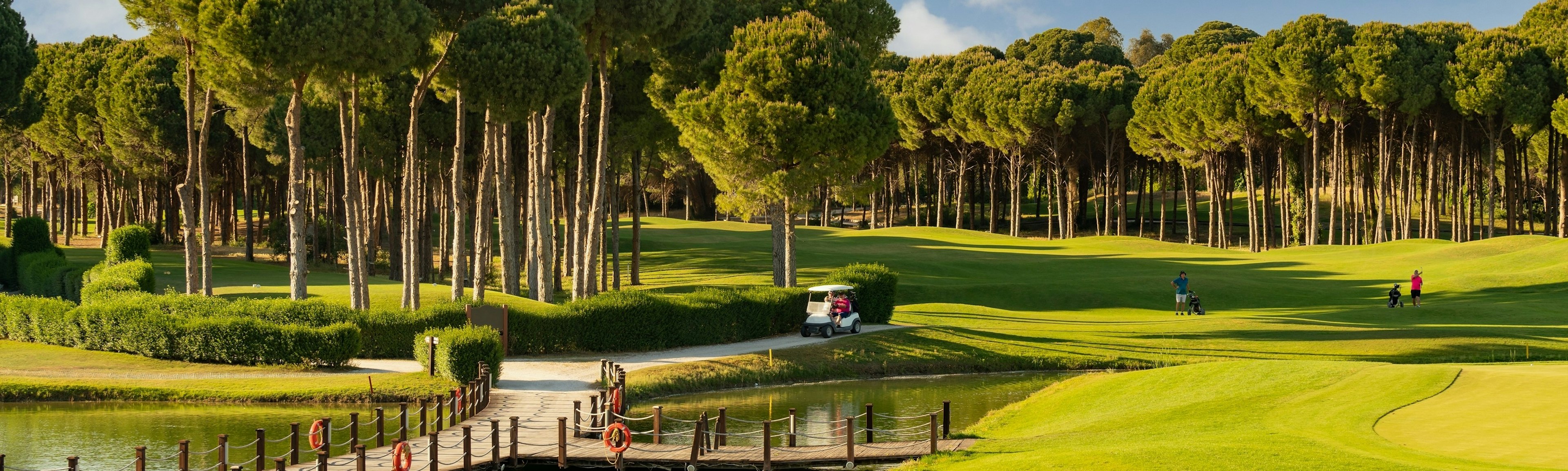 Golf course in Belek, Turkey with lake, golf cart and players