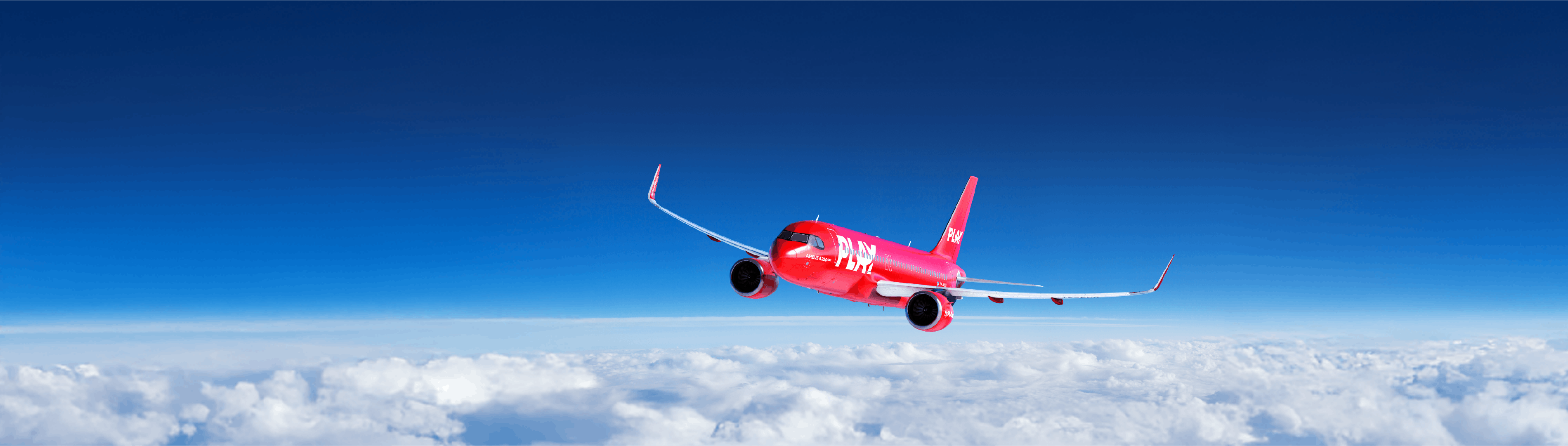 red PLAY airline airplane flying over the clouds