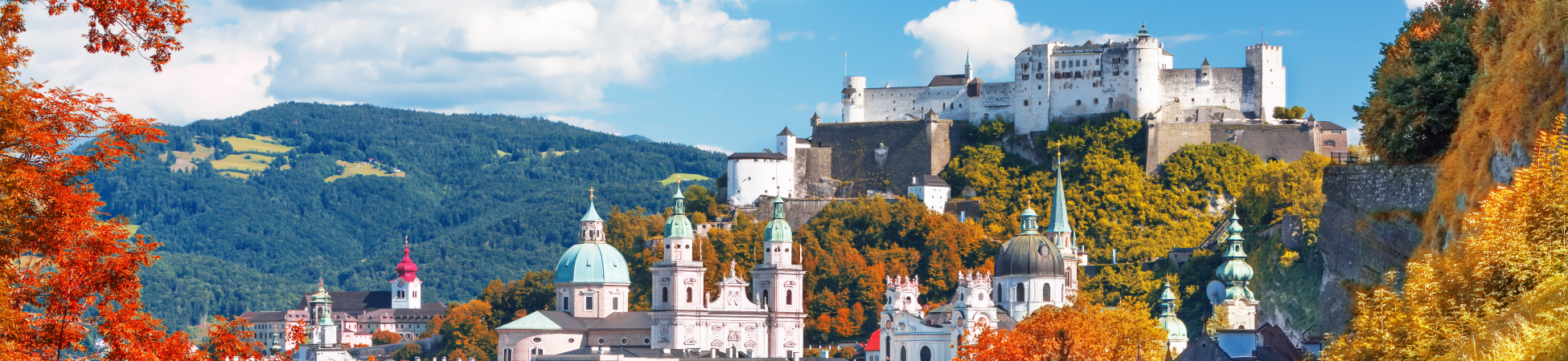 scenic summer autumn view on a city Salzburg skyline with mountains in the background