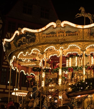 A merry-go-round decorated with Christmas decorations and lights