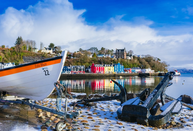 Tobermory harbour in Winter with fishing boat, anchor and the famous colourful houses in the background. Wintery scene