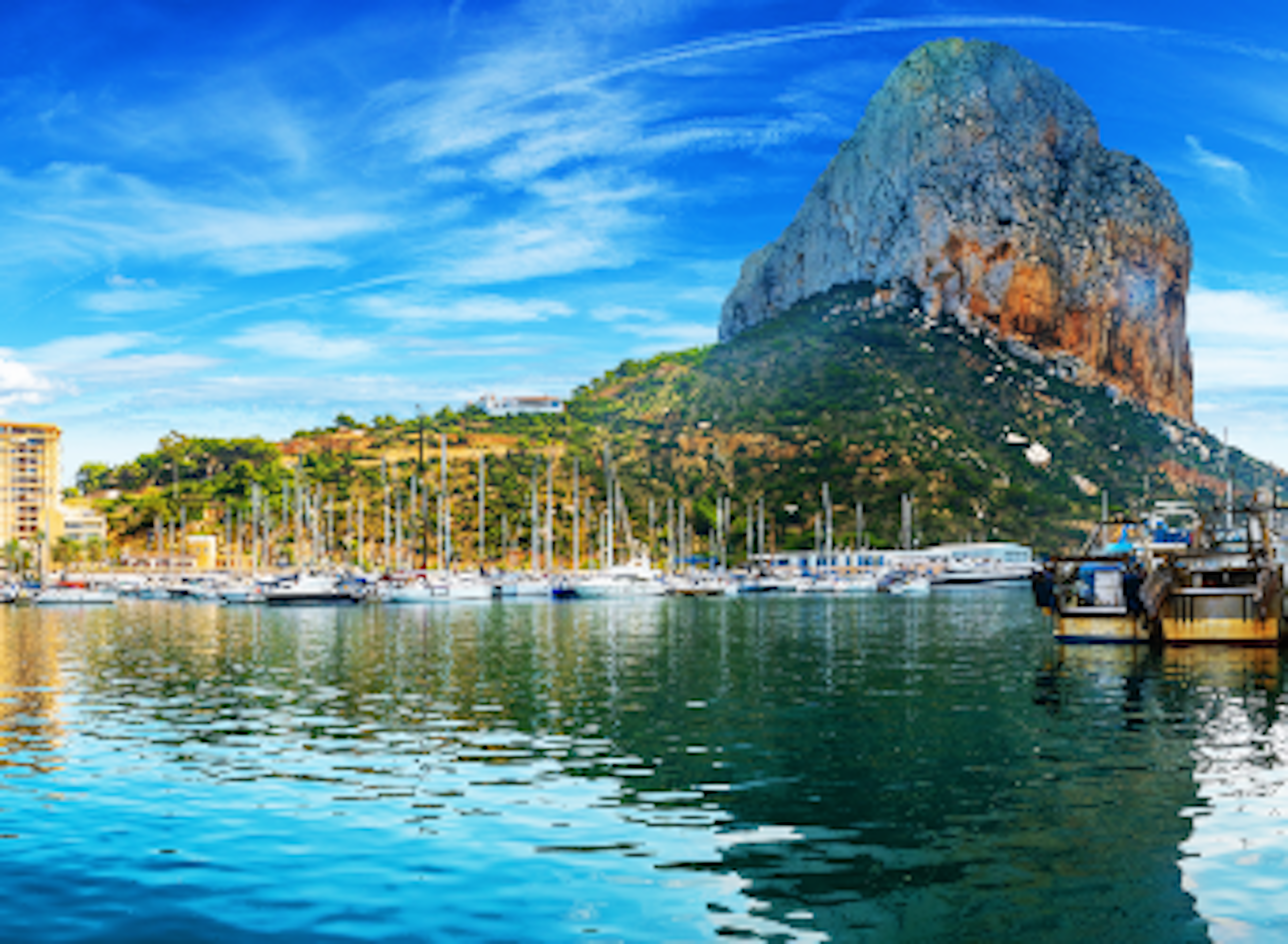 View of boats, mountain and the city by the water