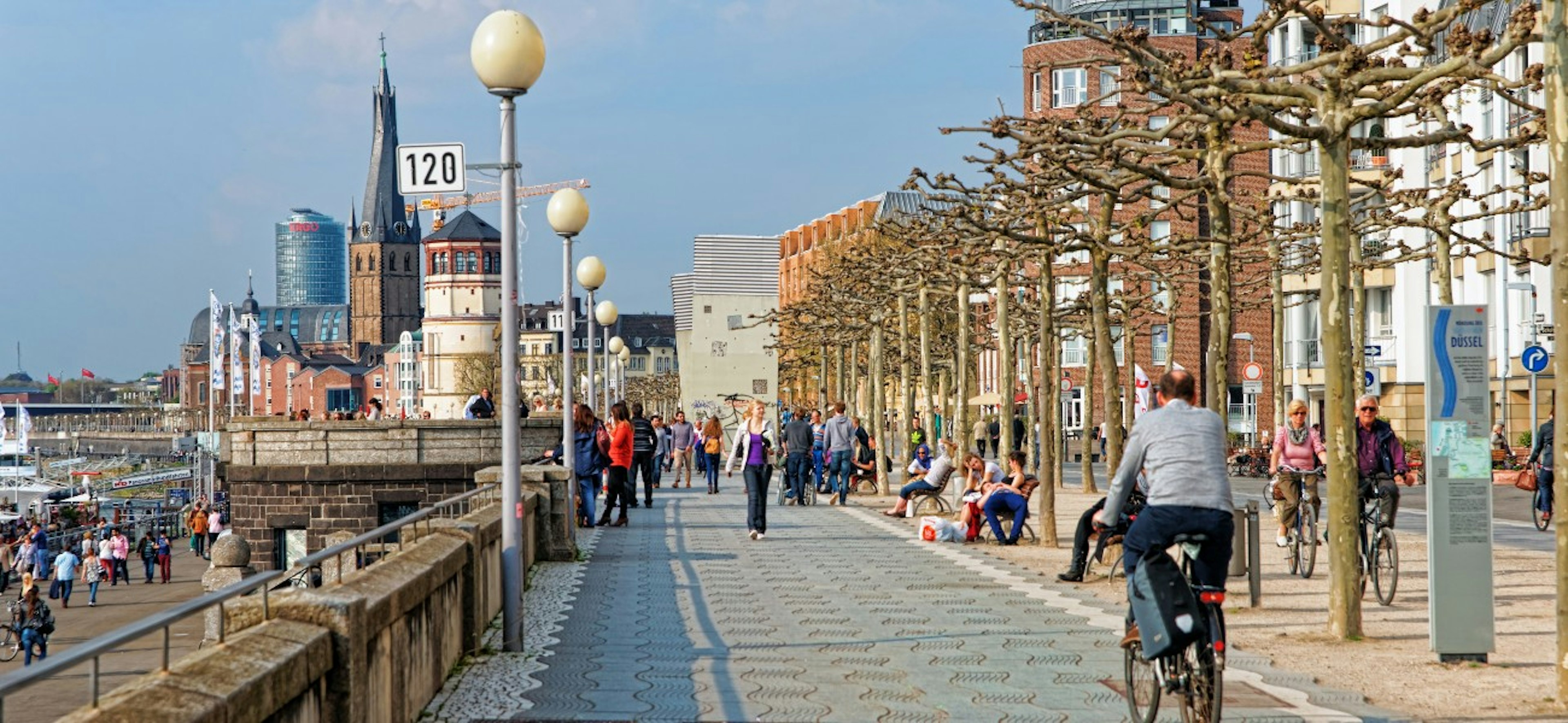 Rhine embankment promenade in the Old city center of Dusseldorf in Germany. Tourists nearby. It is the capital of Rhine Westphalia region.