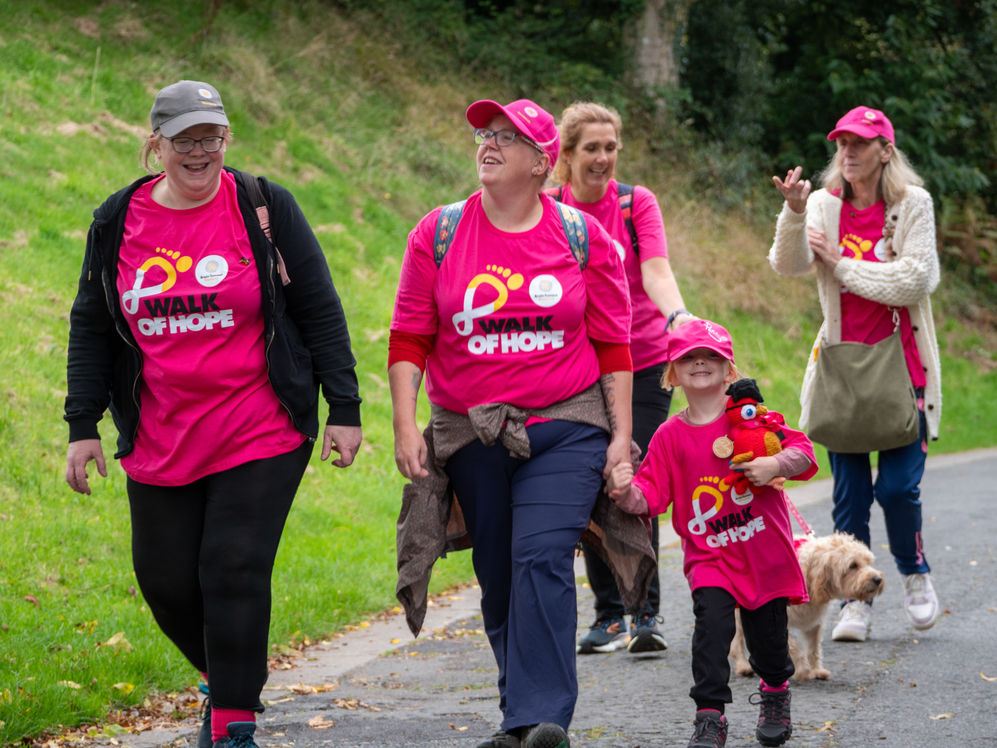 Participants smiling and walking outside. 