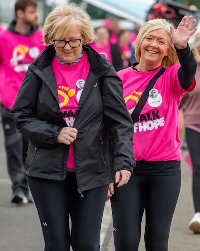 Participants smiling and walking outside.