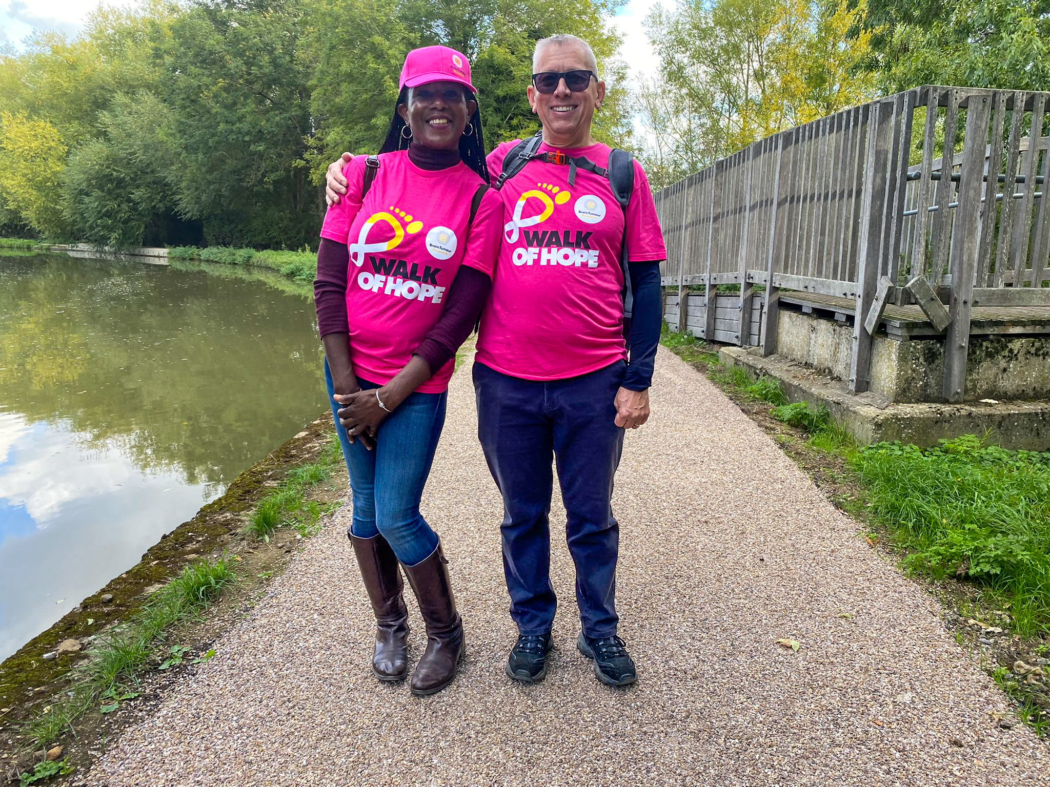Two participants standing arm in arm, wearing Walk of Hope t-shirts.