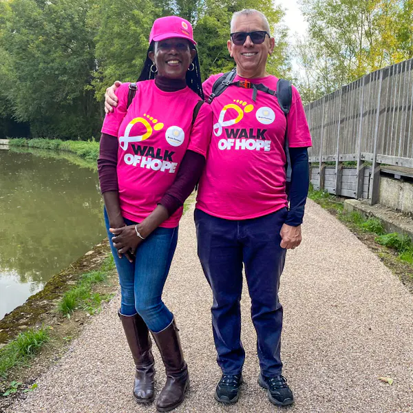 Two participants standing arm in arm, wearing Walk of Hope t-shirts.