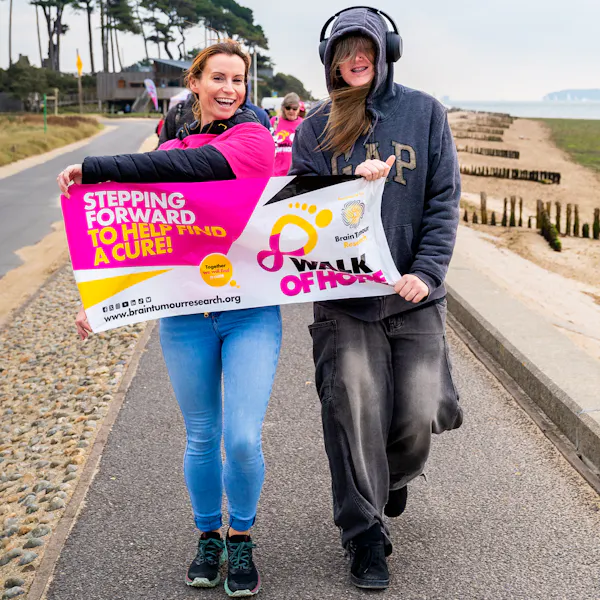 Two participants holding a Walk of Hope sign.