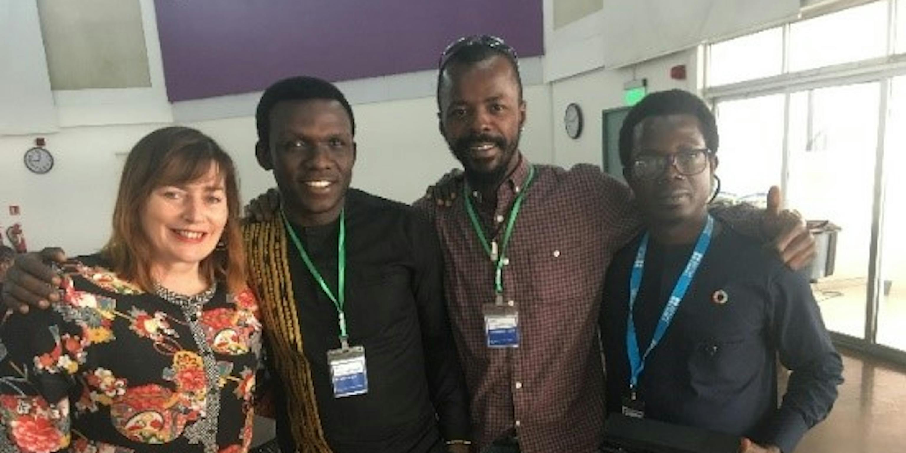 Four people posing together